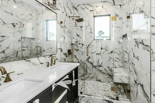 259-09 81st Ave, Glen Oaks, NY 11004 - full bathroom featuring double vanity, a marble finish shower, plenty of natural light, and tile walls