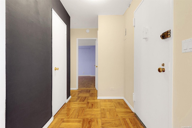 hallway featuring light parquet flooring