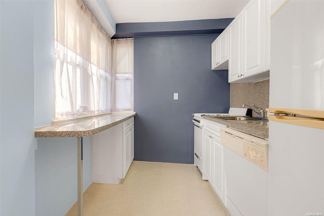 kitchen with white cabinets, white appliances, sink, and tasteful backsplash