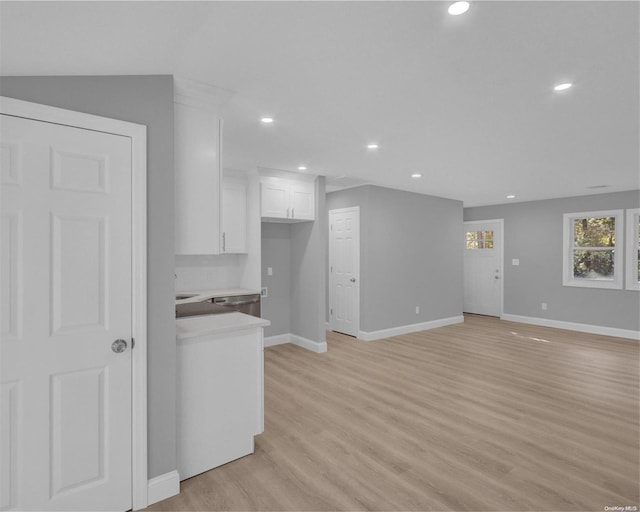 unfurnished living room featuring light hardwood / wood-style flooring and vaulted ceiling