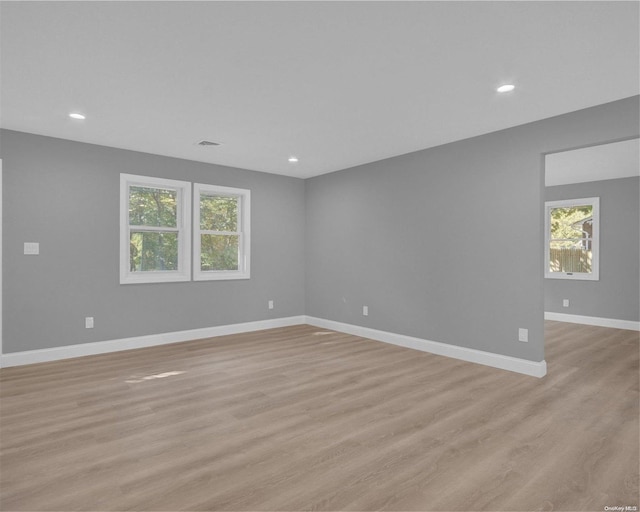 empty room featuring light hardwood / wood-style flooring and a wealth of natural light