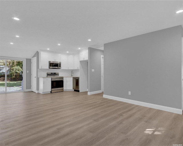 unfurnished living room with light hardwood / wood-style floors