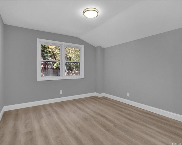 bonus room with light hardwood / wood-style floors and lofted ceiling