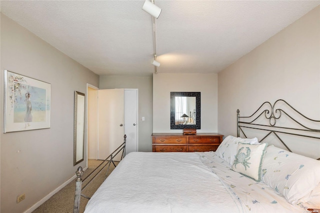 carpeted bedroom with a textured ceiling