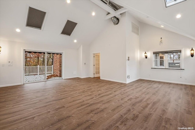 unfurnished living room featuring wood-type flooring and high vaulted ceiling