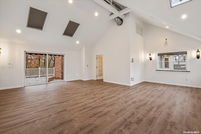 26 Bayville Park Blvd, Bayville, NY 11709 - unfurnished living room with high vaulted ceiling, beamed ceiling, healthy amount of natural light, baseboards, and wood finished floors