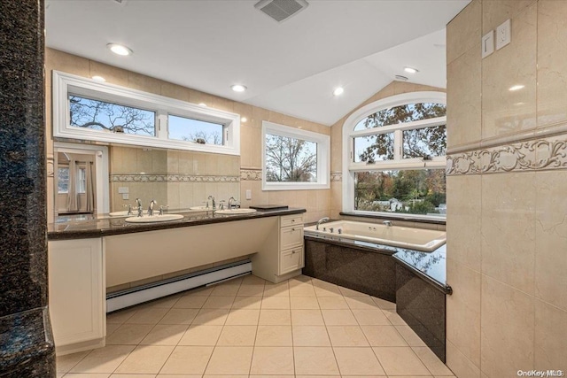 bathroom with lofted ceiling, baseboard heating, tile walls, tile patterned flooring, and vanity