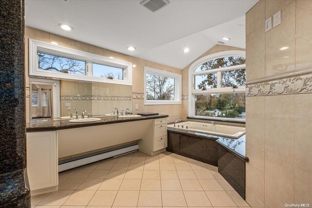 26 Bayville Park Blvd, Bayville, NY 11709 - bathroom with a baseboard radiator, double vanity, a bath, vaulted ceiling, and tile patterned flooring