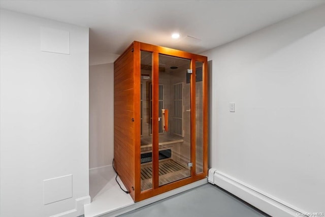 interior space with concrete floors and a baseboard radiator