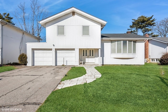 view of front of house with a garage and a front yard