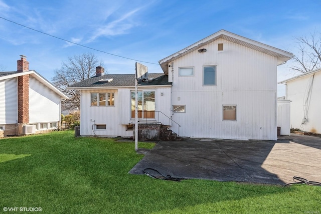 rear view of property with a yard