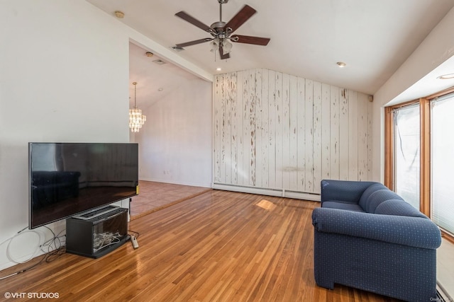 living area with vaulted ceiling with beams, a baseboard radiator, hardwood / wood-style floors, and ceiling fan