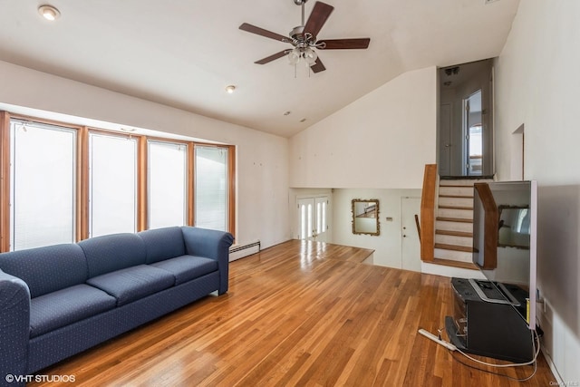 living room featuring baseboard heating, ceiling fan, vaulted ceiling, and hardwood / wood-style floors