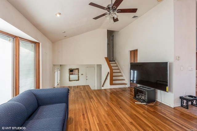 living room with wood-type flooring, lofted ceiling, and ceiling fan