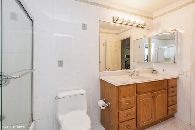 bathroom featuring tile walls, vanity, tile patterned flooring, and a shower with door