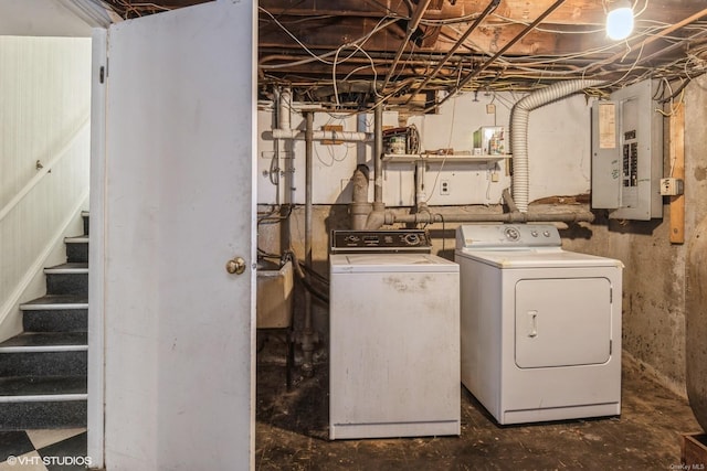 clothes washing area featuring washing machine and clothes dryer and electric panel