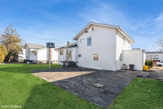 back of house featuring a patio and a lawn