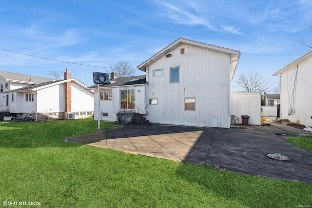 back of property featuring a patio and a lawn