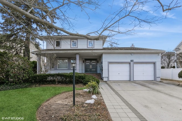 view of front facade featuring stucco siding, concrete driveway, an attached garage, fence, and a front lawn