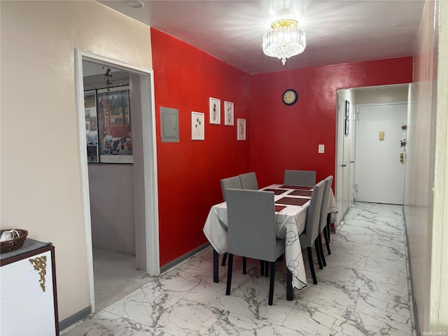 dining area with an inviting chandelier