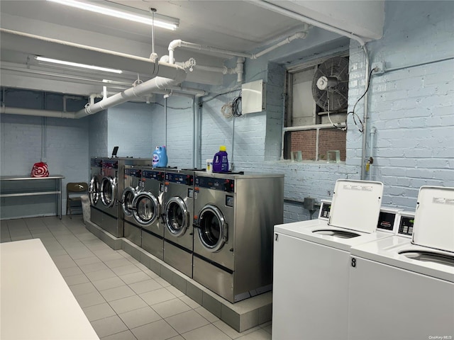 laundry room with light tile patterned flooring and washing machine and clothes dryer