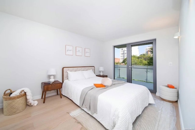 bedroom featuring access to outside and light hardwood / wood-style flooring