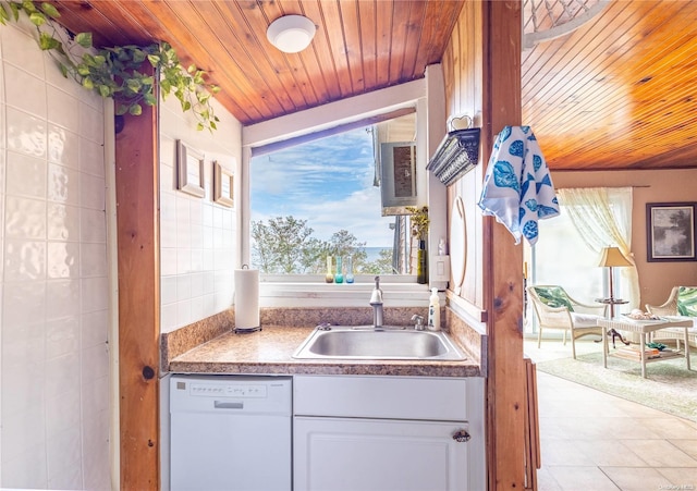 kitchen featuring wood ceiling, white dishwasher, sink, light tile patterned floors, and white cabinetry