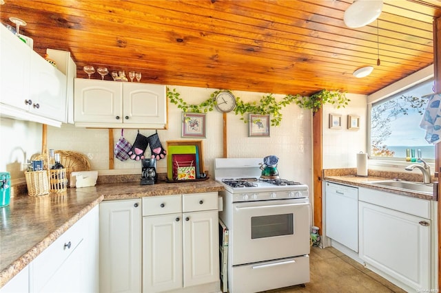 kitchen with white cabinets, white appliances, and sink