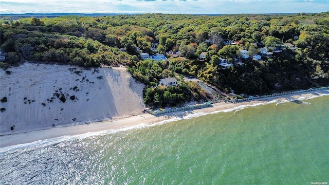 birds eye view of property featuring a water view and a beach view