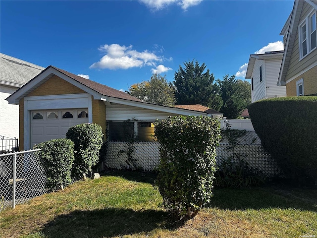 view of home's exterior featuring a yard and a garage