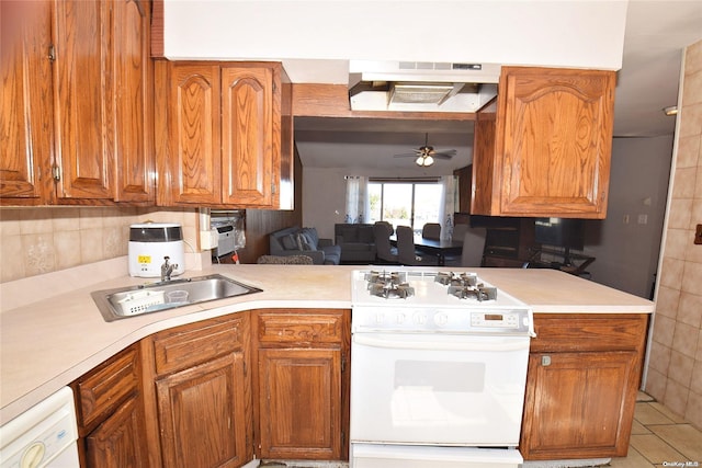 kitchen featuring ceiling fan, sink, kitchen peninsula, white appliances, and light tile patterned flooring