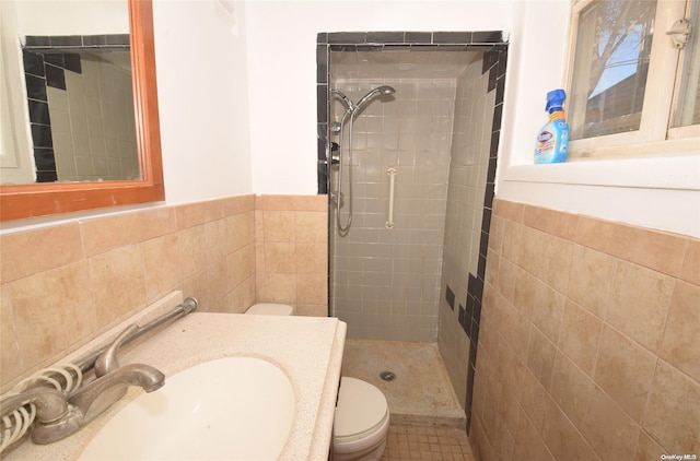 69 E 1st St, Freeport, NY 11520 - full bath with a tile shower, toilet, tile walls, vanity, and a wainscoted wall