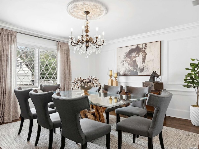 dining area featuring a notable chandelier, wood-type flooring, and ornamental molding