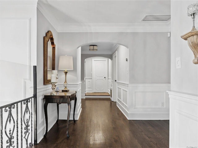 entrance foyer featuring ornamental molding and dark wood-type flooring