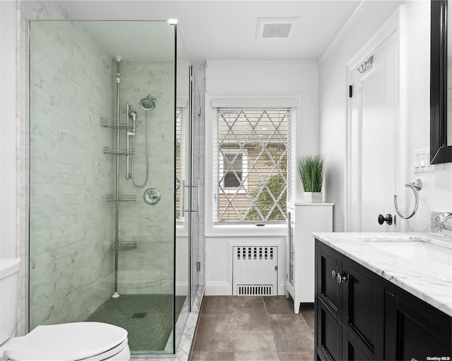 bathroom with vanity, crown molding, toilet, an enclosed shower, and radiator heating unit