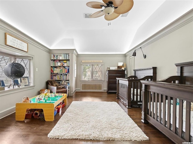 bedroom featuring ceiling fan, dark hardwood / wood-style flooring, crown molding, and vaulted ceiling