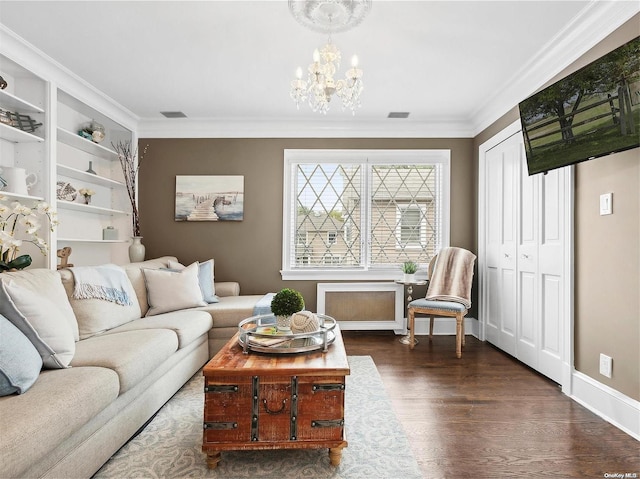 living room with crown molding, dark hardwood / wood-style floors, and a notable chandelier