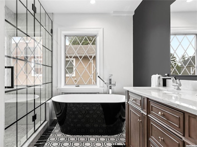 bathroom featuring separate shower and tub, tile patterned flooring, and vanity