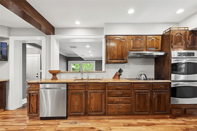 38 Royal Ct, Rockville Centre, NY 11570 - kitchen featuring stainless steel appliances, range hood, light wood-style flooring, light stone countertops, and recessed lighting