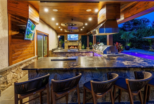 38 Royal Ct, Rockville Centre, NY 11570 - bar with wood ceiling, a textured wall, and an outdoor stone fireplace