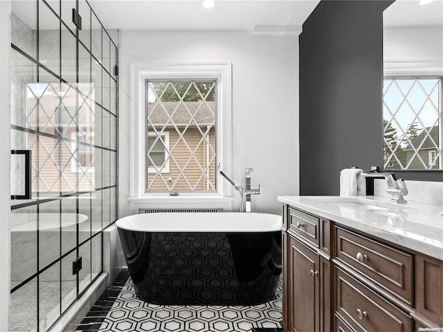 38 Royal Ct, Rockville Centre, NY 11570 - full bath featuring vanity, a freestanding tub, a stall shower, recessed lighting, and tile patterned flooring