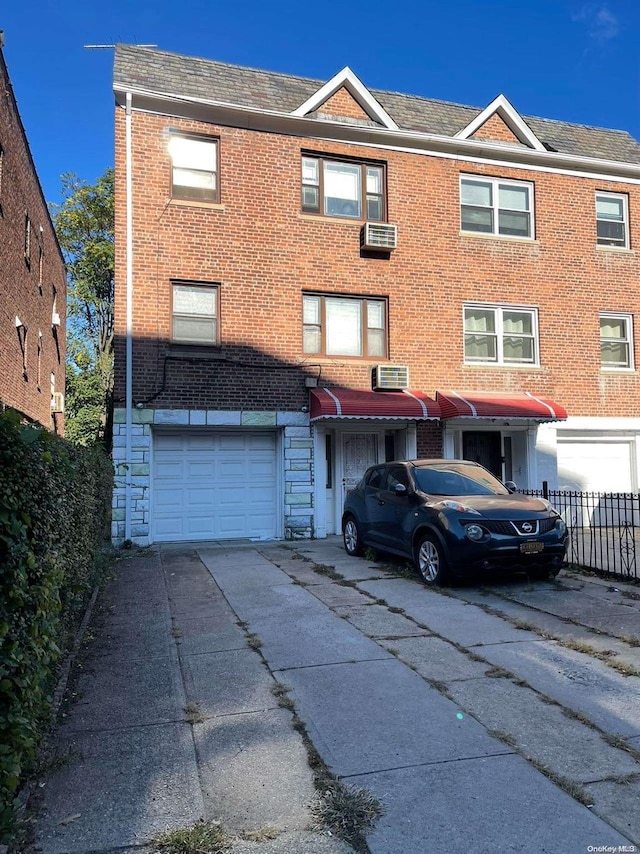 84-35 Corona Ave, Elmhurst, NY 11373 - view of front of house featuring concrete driveway, a garage, brick siding, and a shingled roof