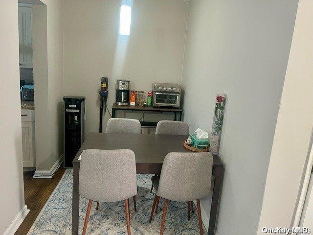 dining room with dark hardwood / wood-style flooring