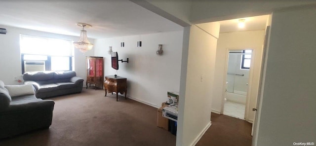 carpeted living room featuring a wealth of natural light, cooling unit, and an inviting chandelier