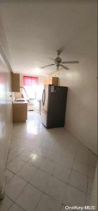 unfurnished living room with ceiling fan