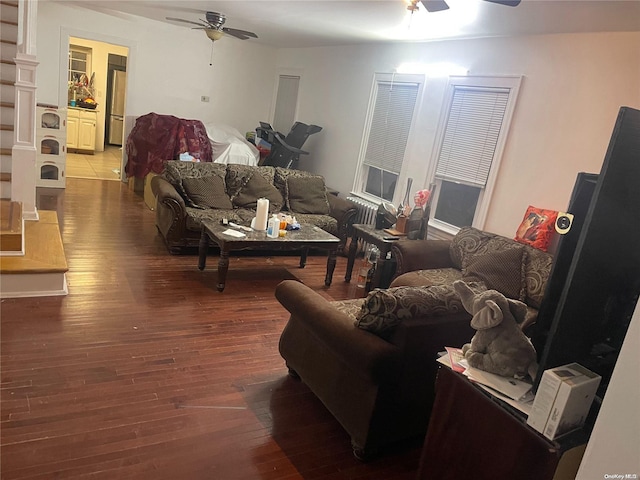 living room featuring ceiling fan and hardwood / wood-style flooring