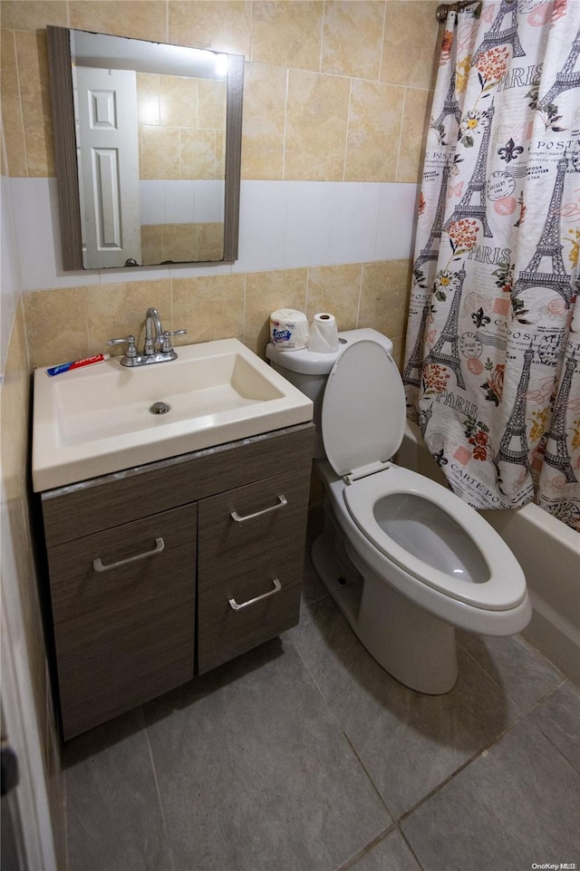 full bathroom featuring tile patterned flooring, vanity, backsplash, and tile walls