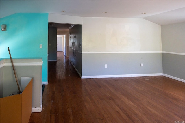 unfurnished room with lofted ceiling and dark wood-type flooring