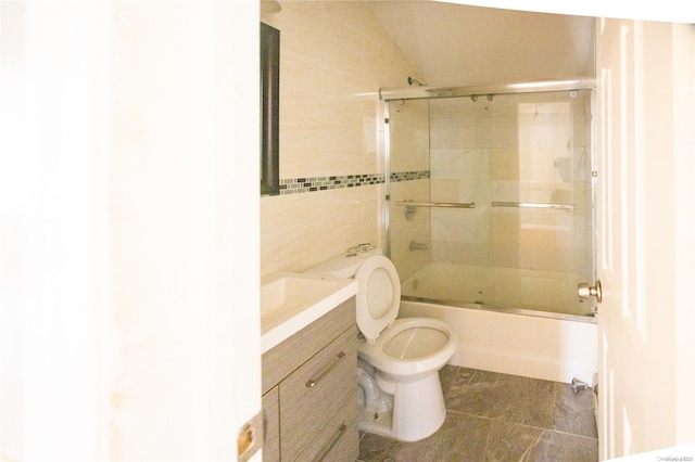 full bathroom with tile patterned flooring, vanity, toilet, and shower / bath combination with glass door