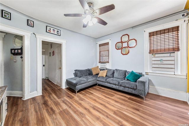 living room with ceiling fan and hardwood / wood-style flooring